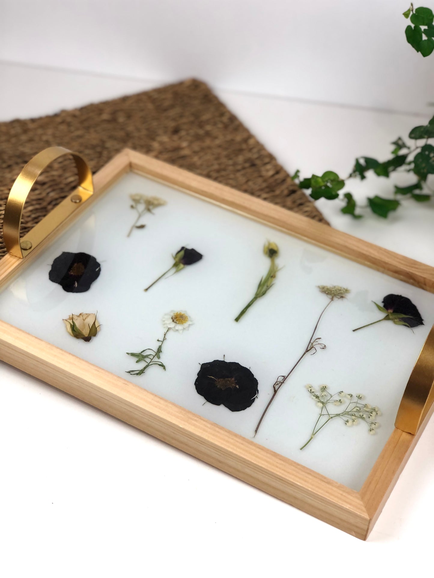Wooden tray with gold handles.