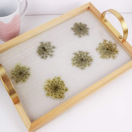 Wooden tray with gold handles.