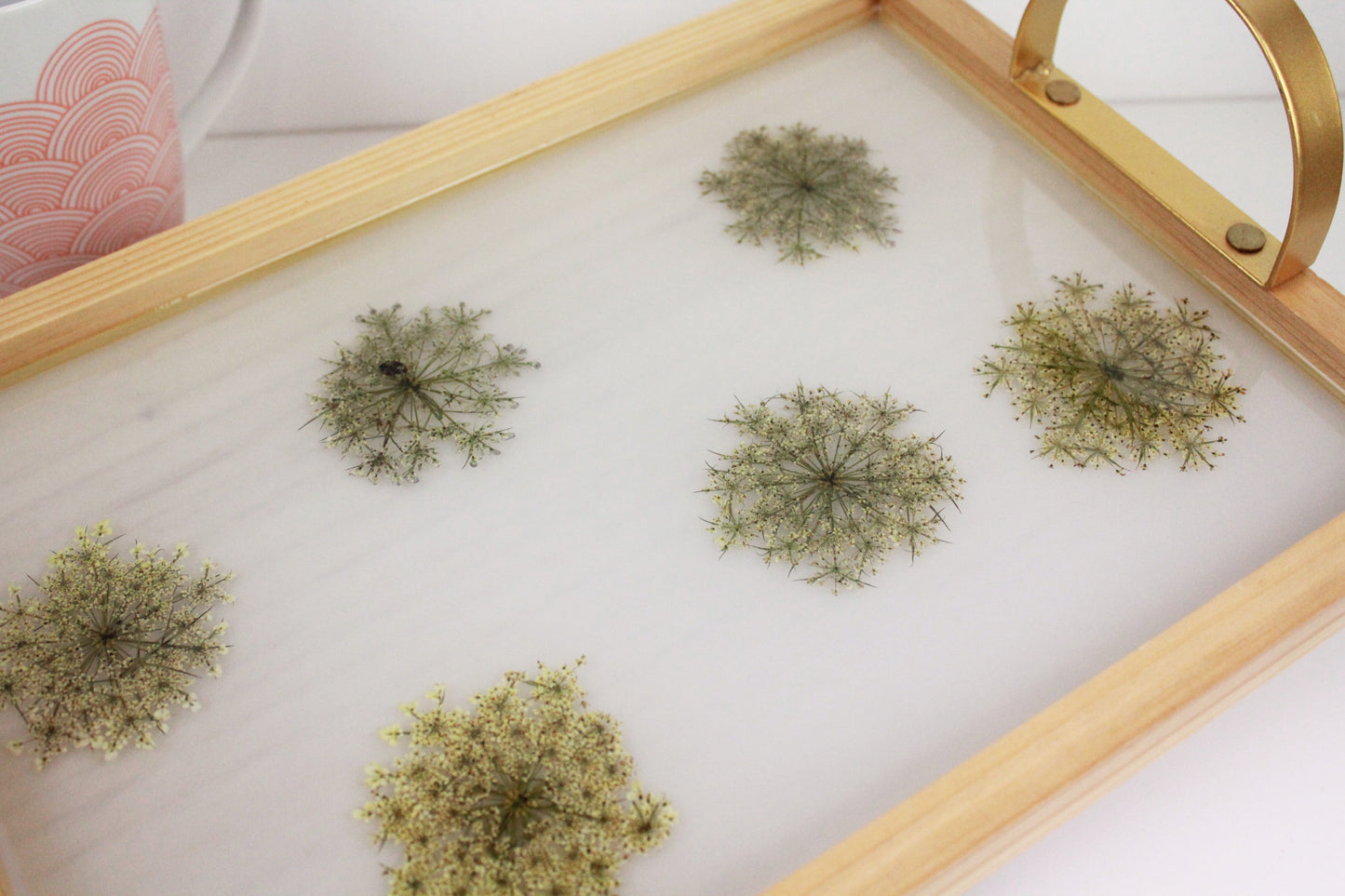 Wooden tray with gold handles.