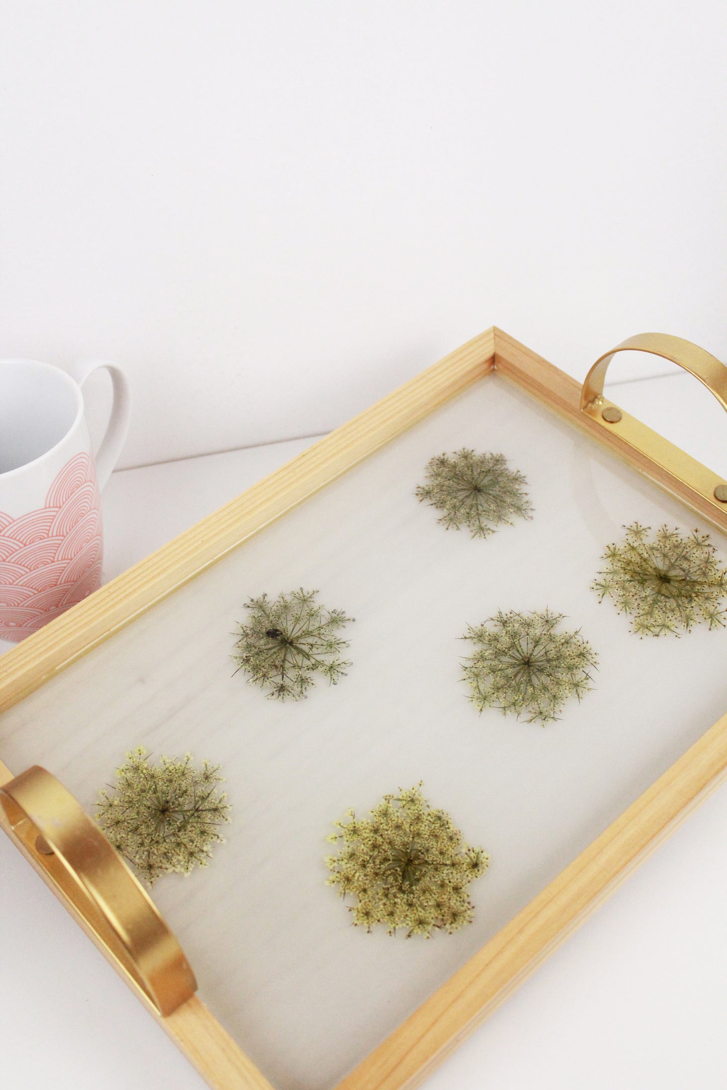 Wooden tray with gold handles.